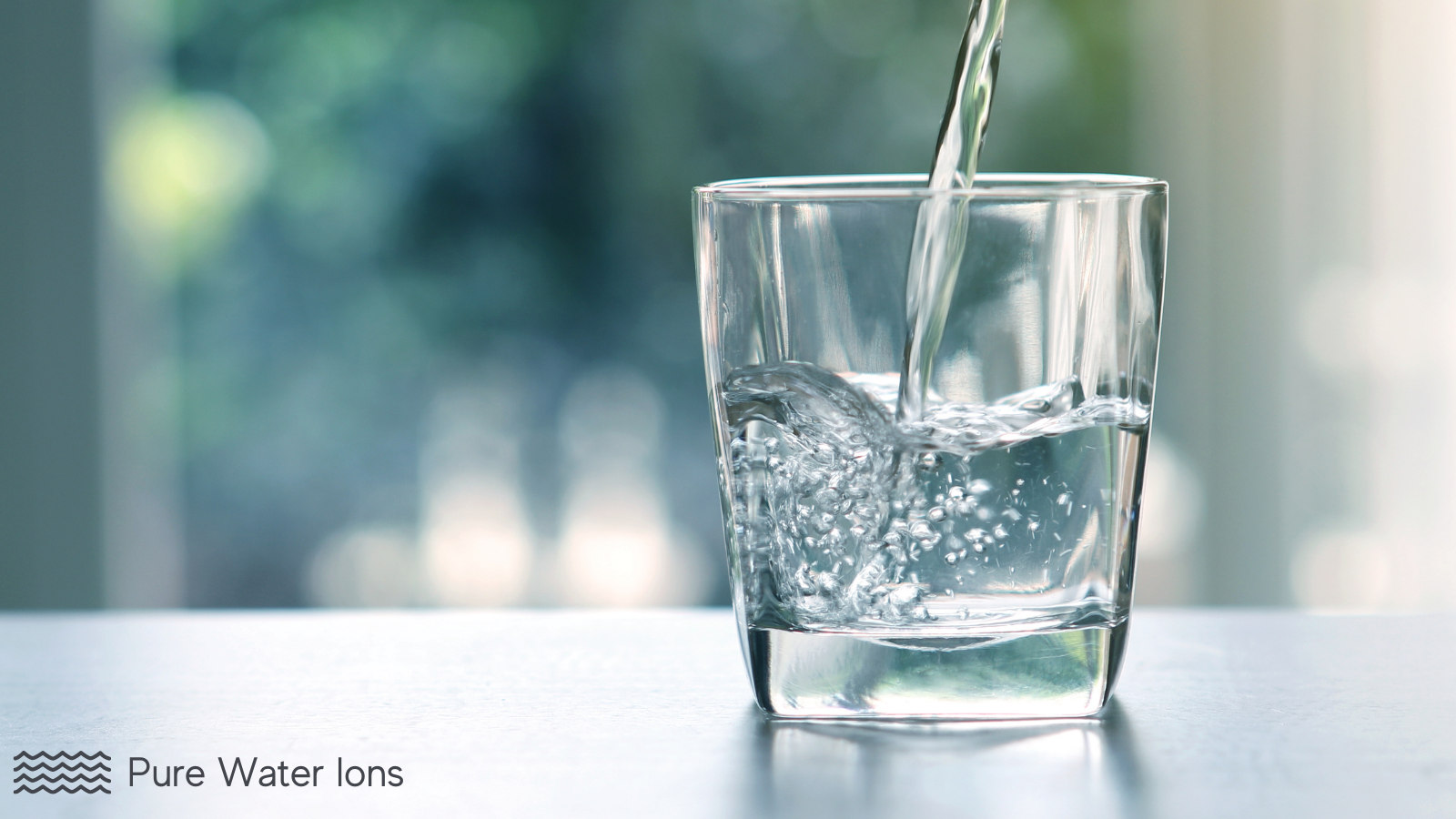 a glass of ionized water from an alkaline water machine