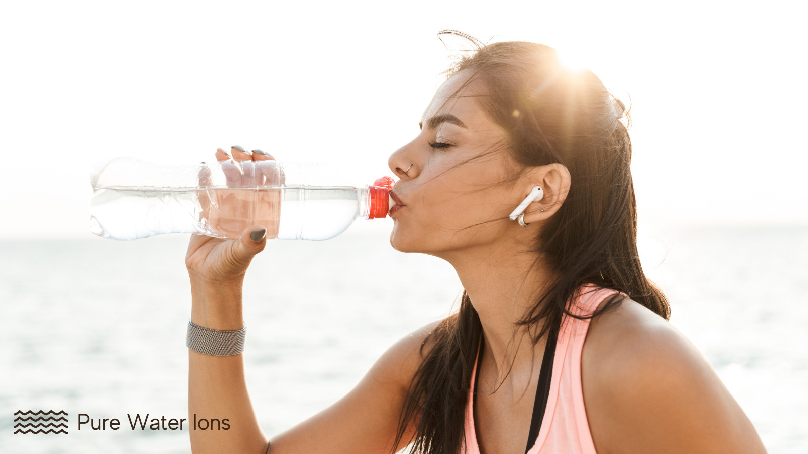 woman drinking a bottle of filtered ionized water