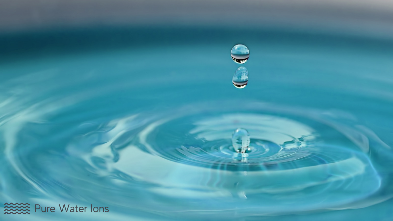 a drop of water falling into a pool of water