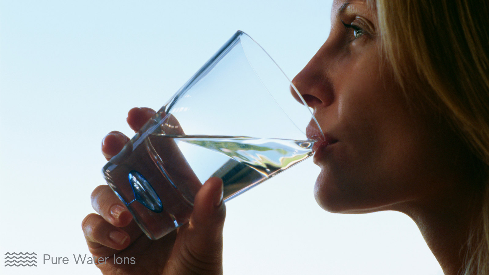 woman drinking a glass of freshly filtered water