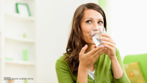 lady drinking glass of pure water and smiling