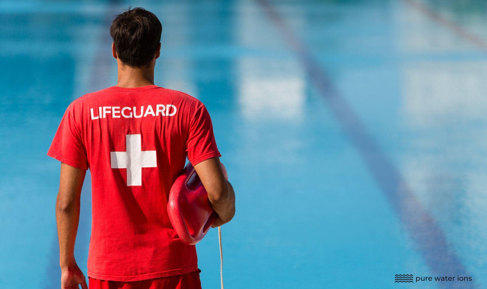lifeguard standing next to a pool